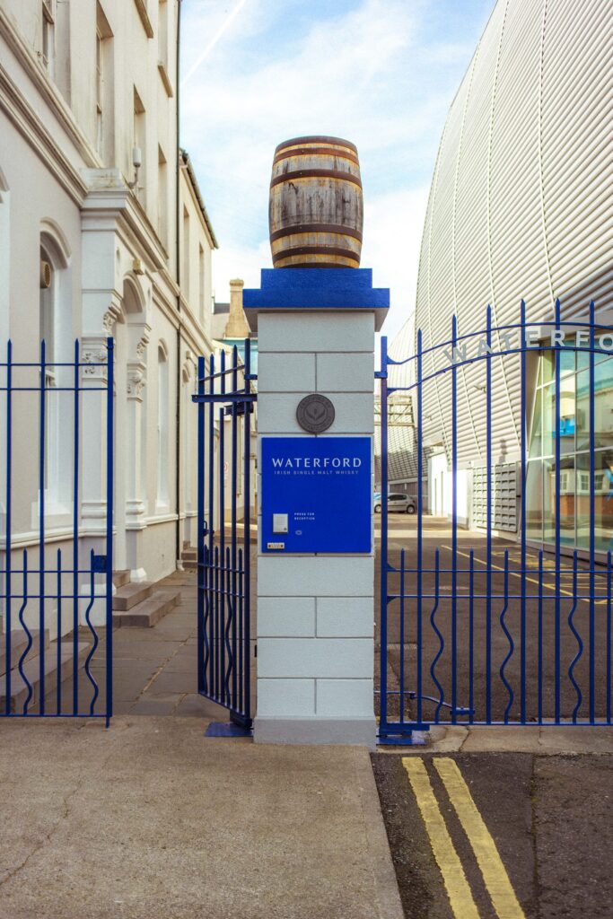 An oak cask set on the stone gate pillar at the distillery entrance