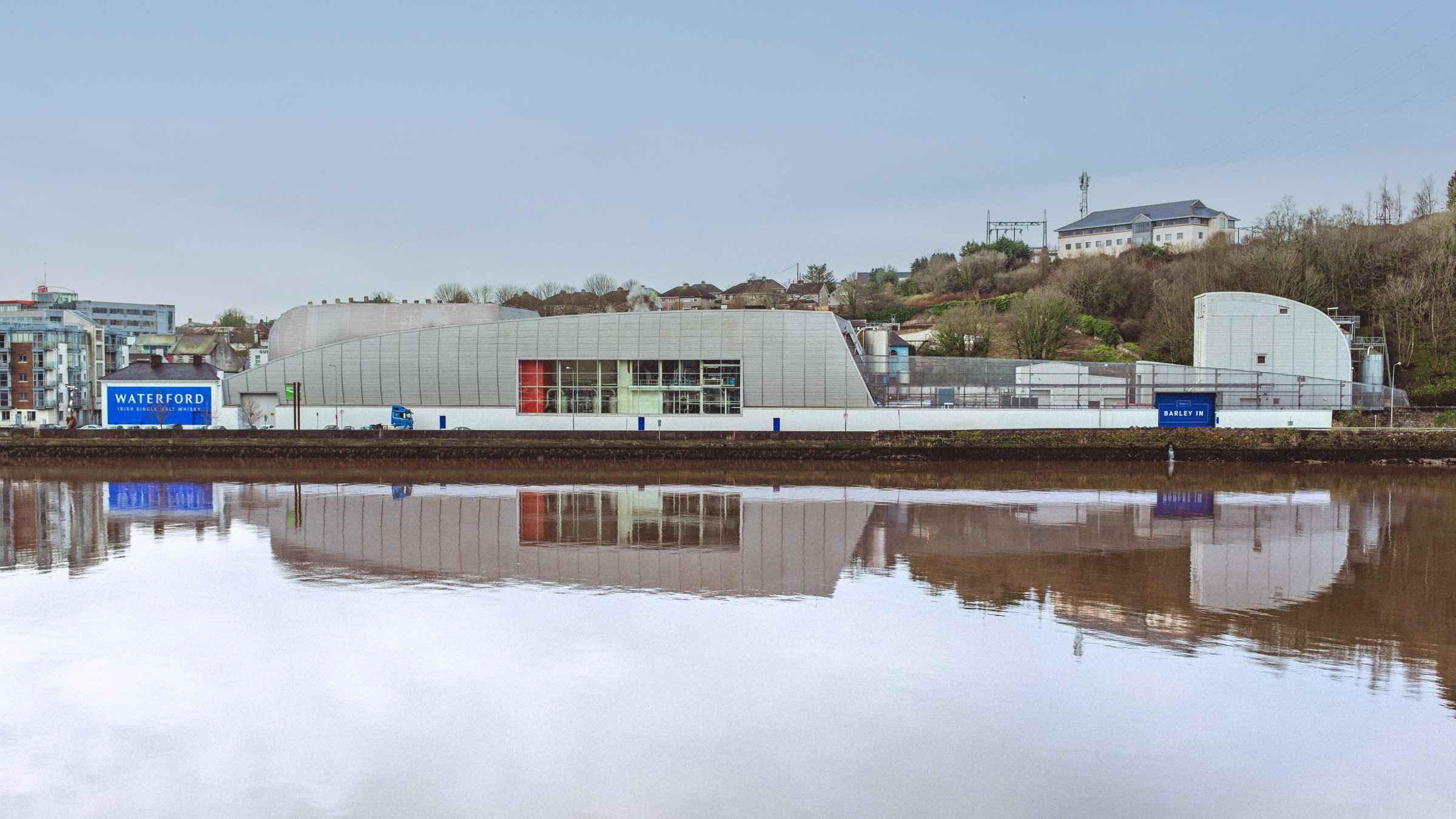 The distillery buildings on Grattan Quay, reflected in the River Suir
