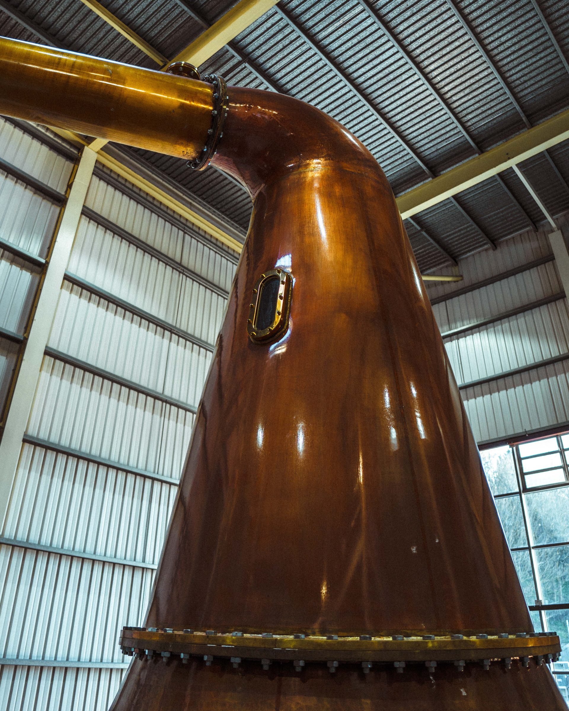 The polished copper neck of a pot still